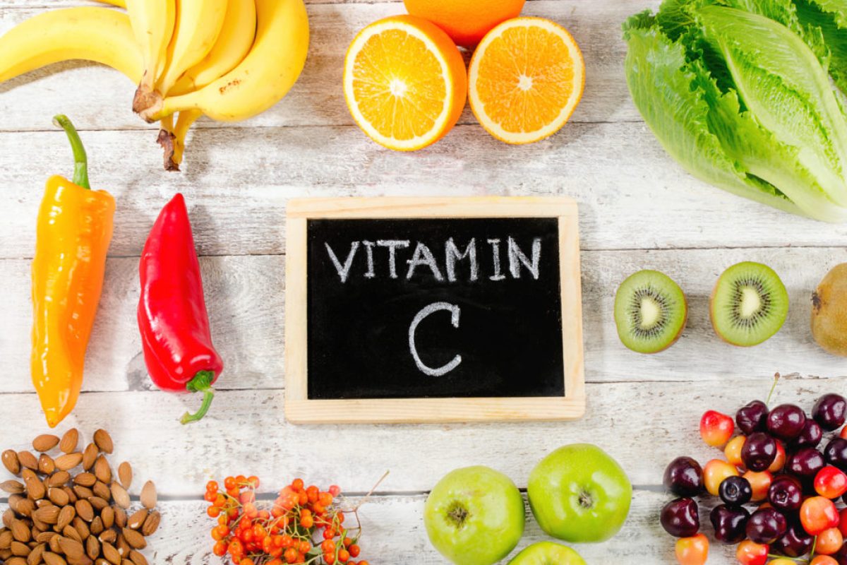 Foods High in vitamin C on a wooden background.