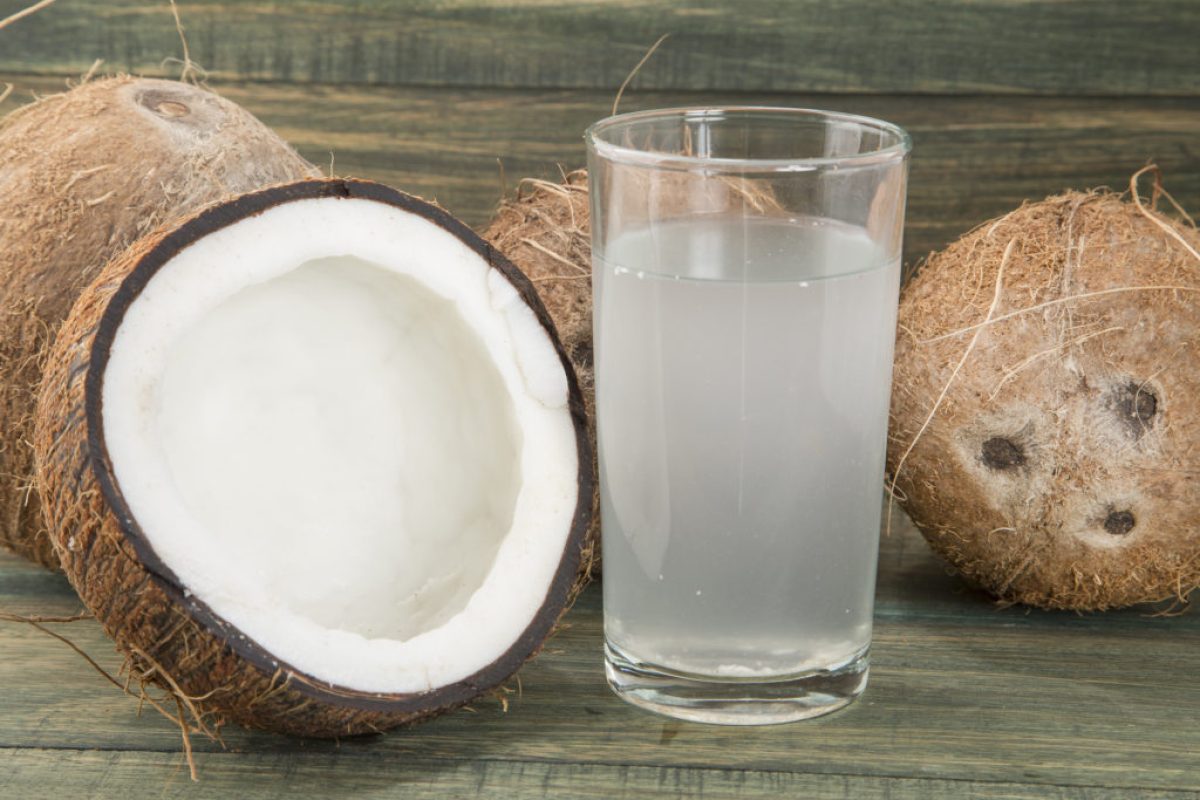 Coconut water on the wooden background (Cocos nucifera)